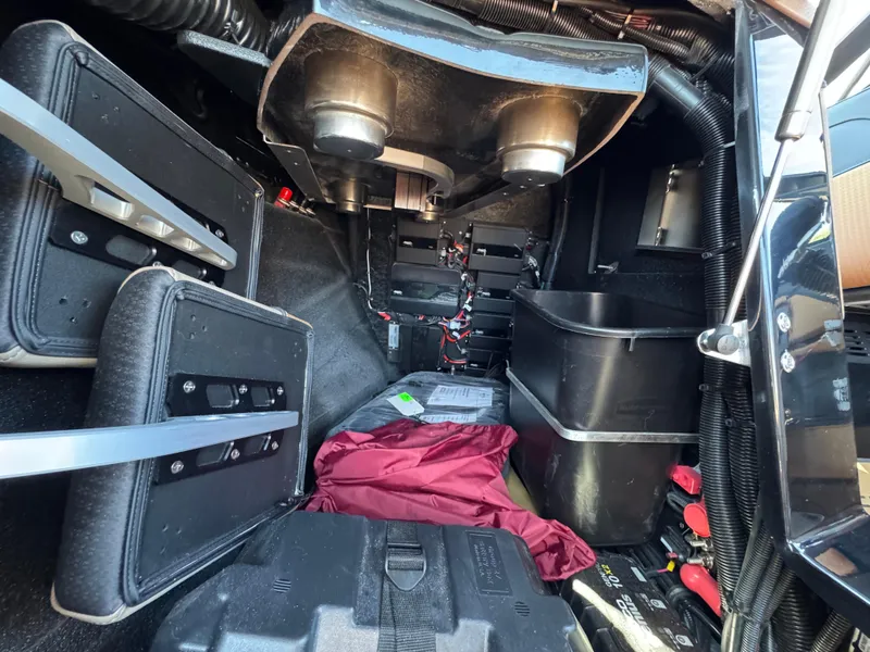 Slide: The Image of Interior view of a 2025 Centurion RI 245 boat, showcasing storage compartments and equipment. - 25