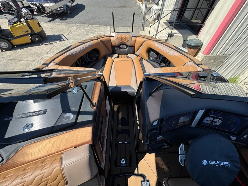 Slide: The Image of Interior view of 2025 Centurion RI 245 boat with luxurious seating and modern dashboard. - 26