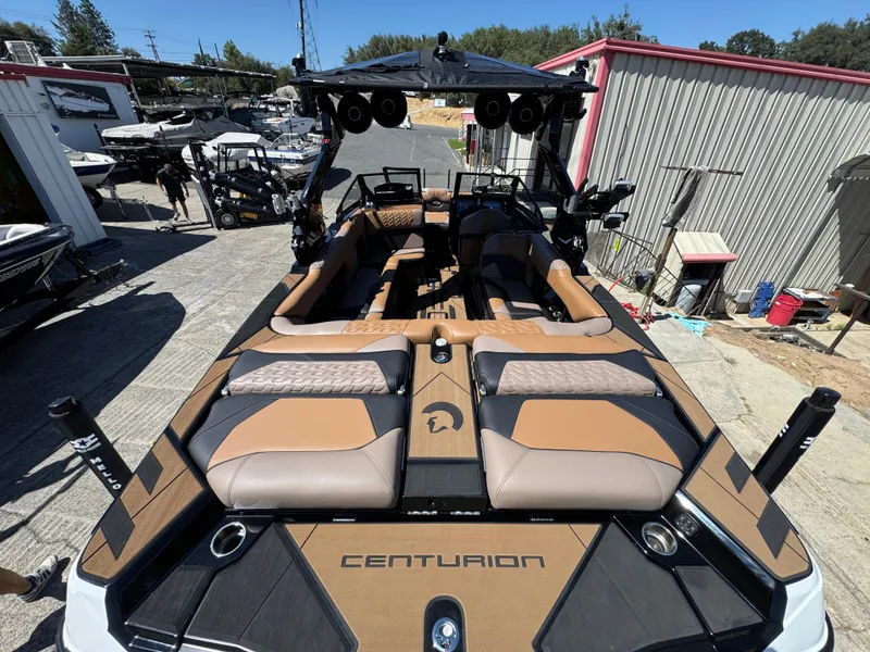 Slide: The Image of 2025 Centurion RI 245 boat with luxurious seating and modern design in a marina setting. - 3