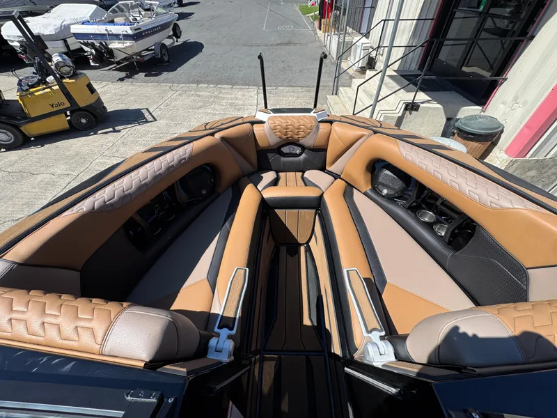 Slide: The Image of Luxurious interior of 2025 Centurion RI 245 boat with tan and black seating. - 31