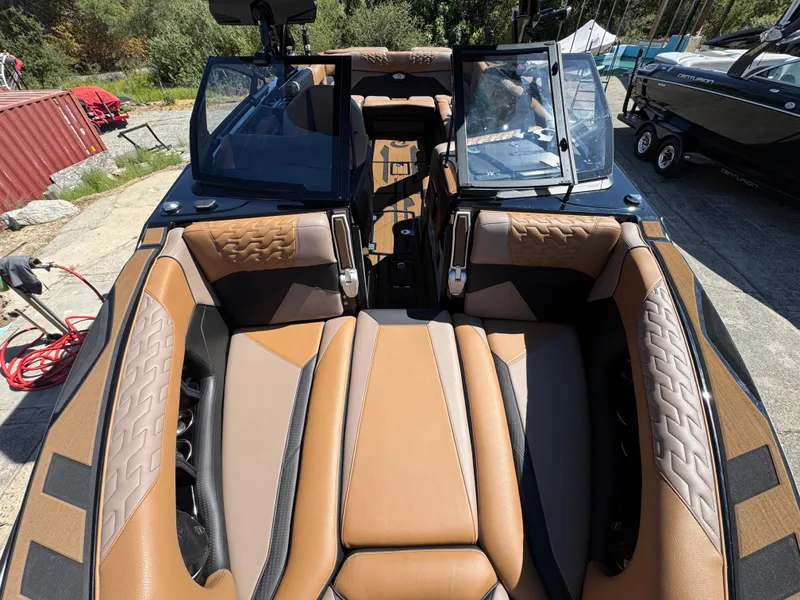 Slide: The Image of Luxurious interior of 2025 Centurion RI 245 boat with tan and black seating. - 35
