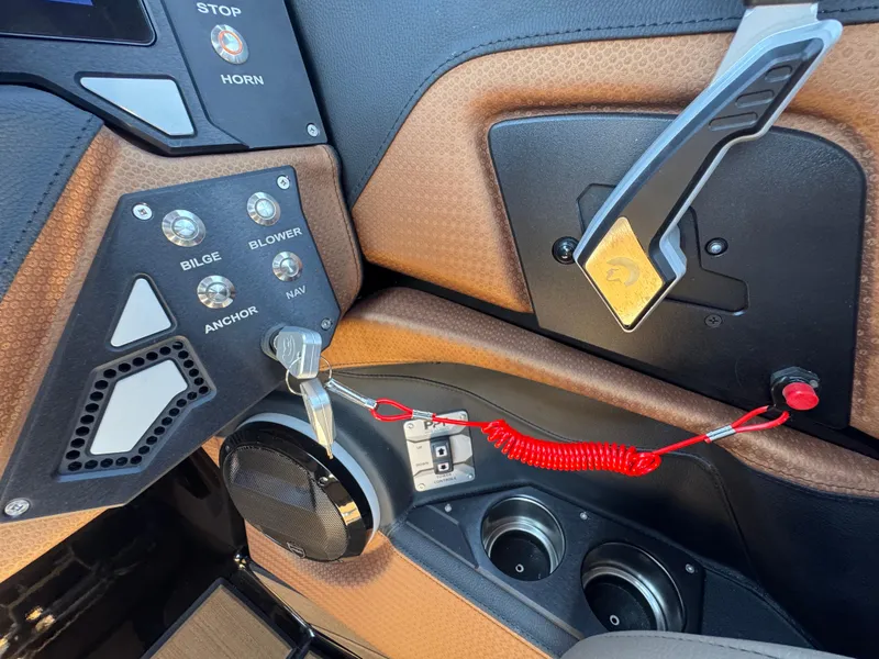 Slide: The Image of Control panel of 2025 Centurion RI 245 boat with switches and key ignition. - 41