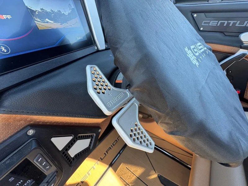 Slide: The Image of 2025 Centurion RI 245 boat interior with steering wheel cover and control panel. - 43