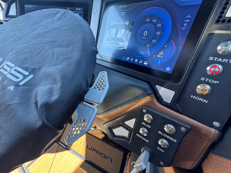 Slide: The Image of Dashboard of a 2025 Centurion RI 245 boat with digital display and control buttons. - 44
