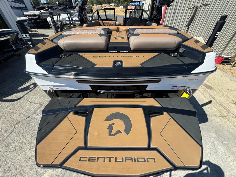 Slide: The Image of 2025 Centurion RI 245 boat with sleek design and comfortable seating at a marina. - 48