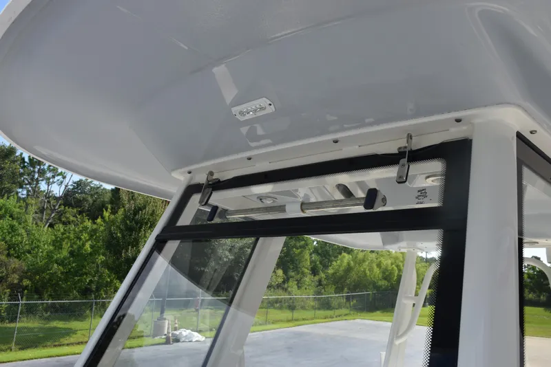 Slide: The Image of 2019 Robalo R272 Center Console boat's T-top and windshield detail. - 16