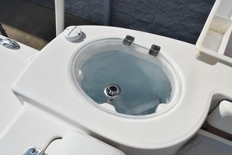 Slide: The Image of 2019 Robalo R272 Center Console livewell with clear lid and textured surface. - 22