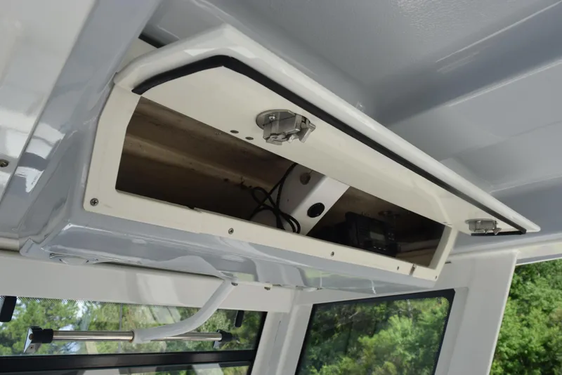 Slide: The Image of Open storage compartment in 2019 Robalo R272 Center Console boat. - 26