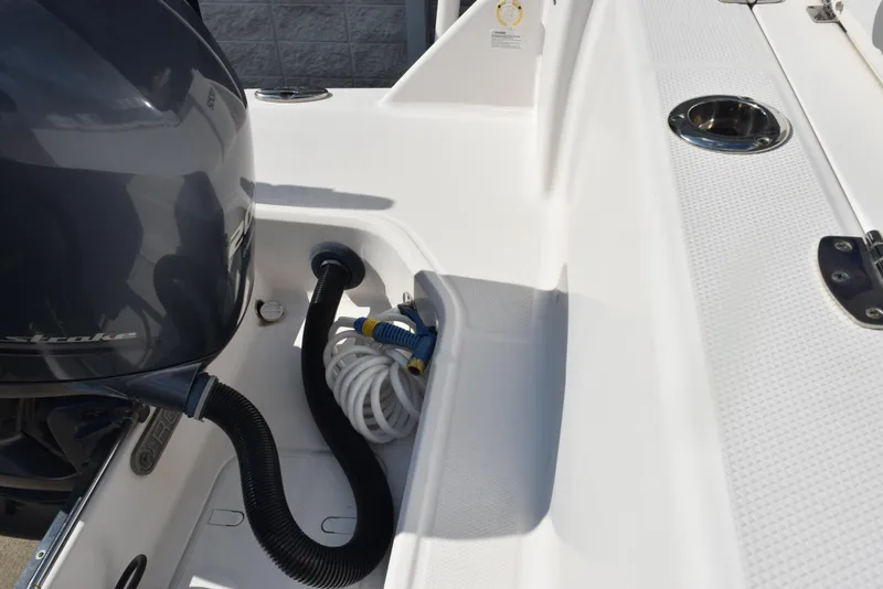 Slide: The Image of 2019 Robalo R272 Center Console boat deck with engine and coiled hose. - 28