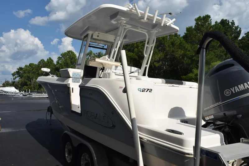 Slide: The Image of 2019 Robalo R272 Center Console boat with Yamaha engine, parked outdoors. - 6