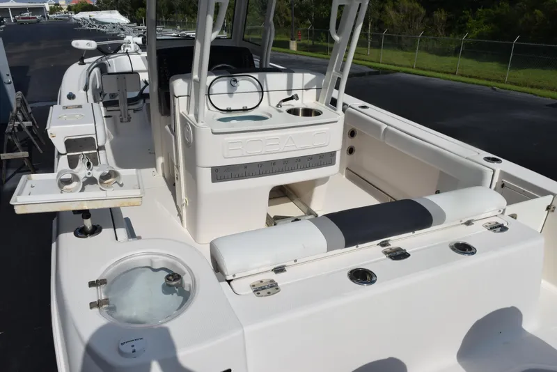 Slide: The Image of 2019 Robalo R272 Center Console boat interior with fishing amenities and seating. - 7