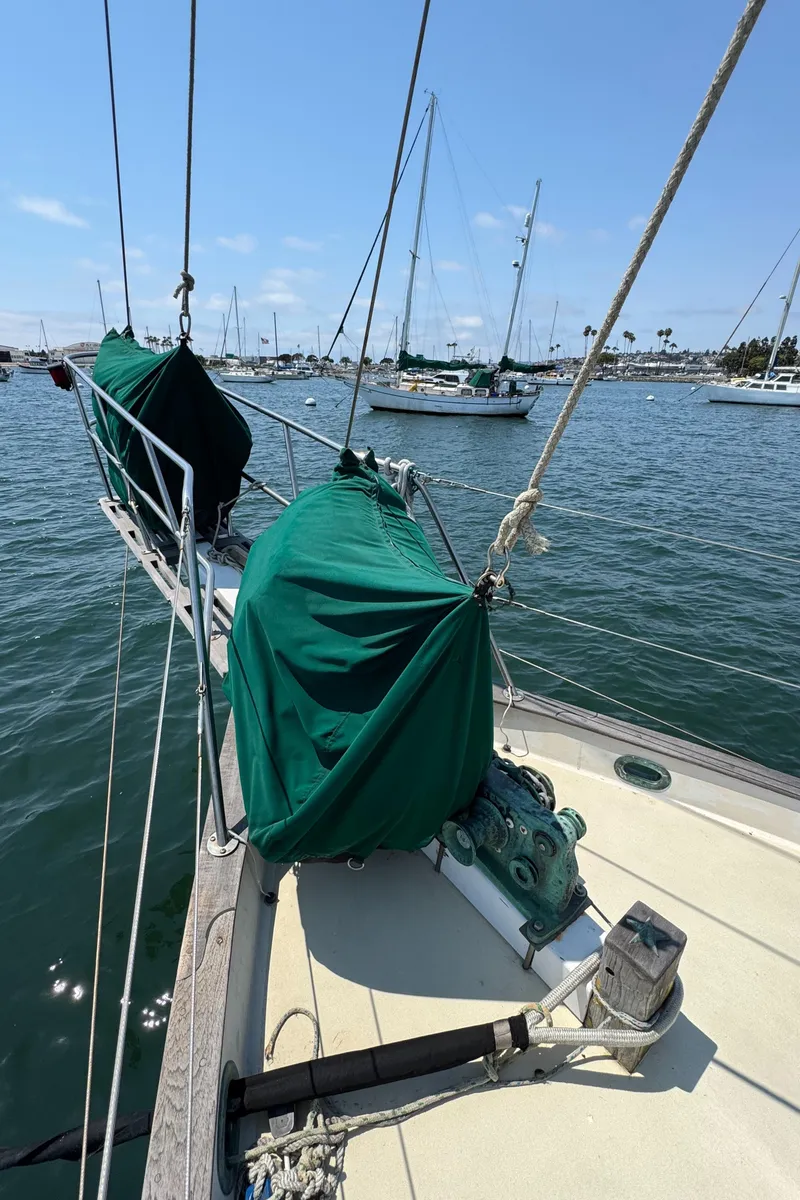 Slide: The Image of Sailboat deck view, Bluewater Ingrid 38, 1985, moored in a sunny marina. - 10