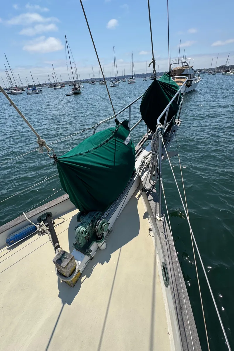 Slide: The Image of Sailboat deck view, Bluewater Ingrid 38, 1985, anchored in a marina with other boats. - 11