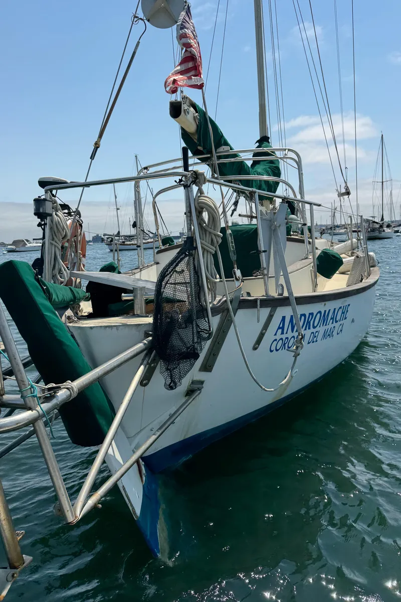 Slide: The Image of Sailboat "Andromache," Bluewater Ingrid 38, 1985, docked in a marina with clear skies. - 12