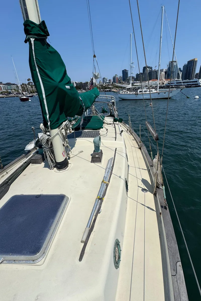 Slide: The Image of Sailboat Bluewater Ingrid 38, 1985 model, docked in marina with city skyline in background. - 17