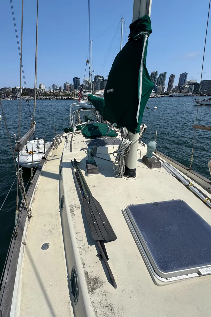 Slide: The Image of 1985 Bluewater Ingrid 38 sailboat docked with city skyline in background. - 18