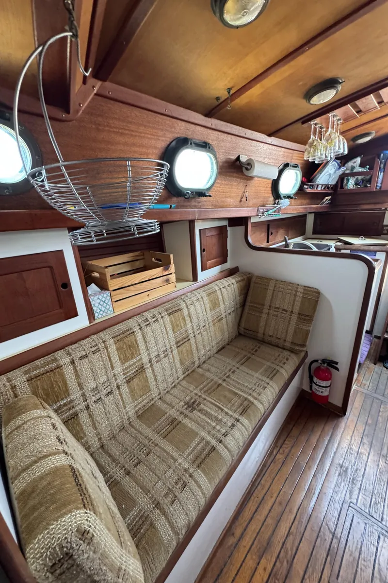 Slide: The Image of Interior of 1985 Bluewater Ingrid 38 sailboat with cozy seating and wooden accents. - 22