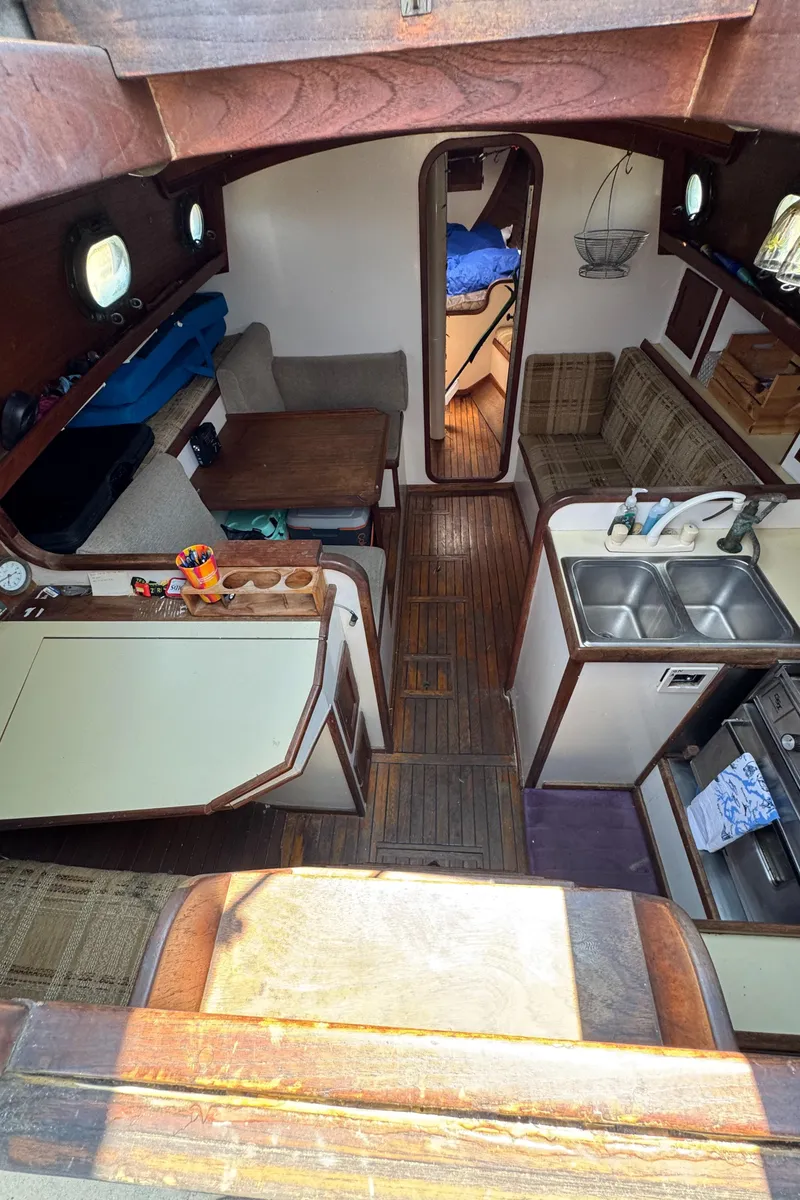 Slide: The Image of Interior of 1985 Bluewater Ingrid 38 sailboat with cozy seating and compact kitchen. - 40