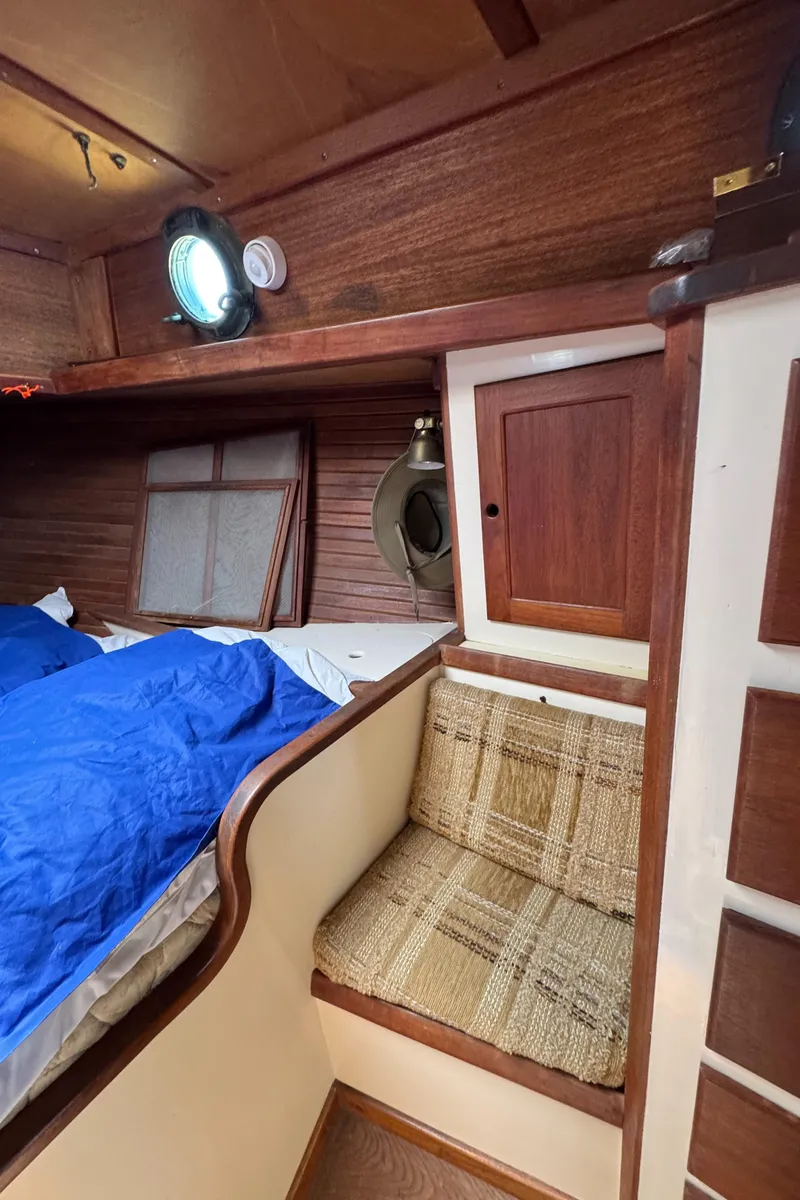 Slide: The Image of Cozy cabin interior of 1985 Bluewater Ingrid 38 sailboat with wooden finish and seating. - 41