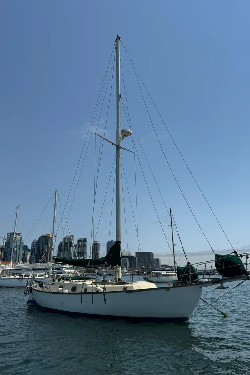 Slide: The Image of 1985 Bluewater Ingrid 38 sailboat docked in urban marina, clear blue sky. - 5