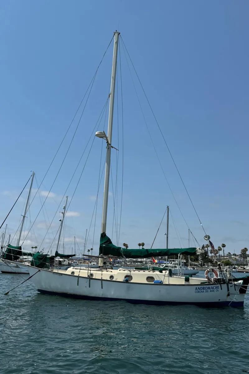 Slide: The Image of 1985 Bluewater Ingrid 38 sailboat docked in a marina under clear blue skies. - 7