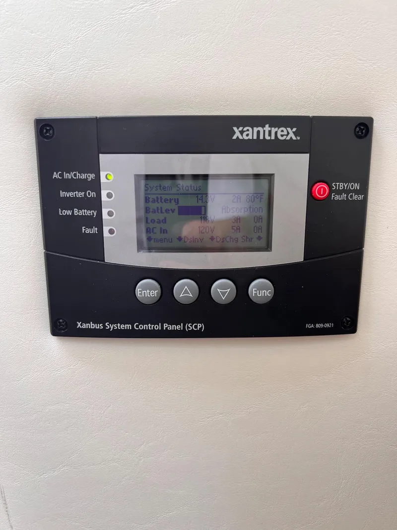 Slide: The Image of Xantrex system control panel on 2019 Cruisers Yachts 338 IO, displaying battery and inverter status. - 32