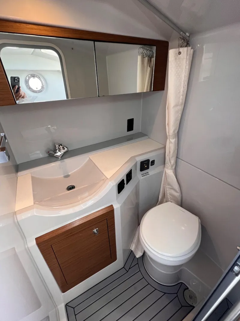 Slide: The Image of 2019 Cruisers Yachts 338 IO bathroom with modern fixtures and wood accents. - 39