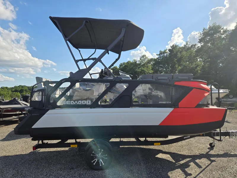 Slide: The Image of 2023 Sea-Doo Switch Cruise 18 pontoon boat on trailer, sunny day, outdoor setting. - 3