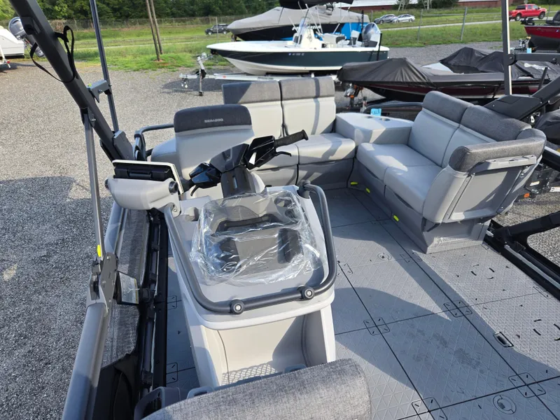 Slide: The Image of 2023 Sea-Doo Switch Cruise 18 interior with seating and control console, parked outdoors. - 8