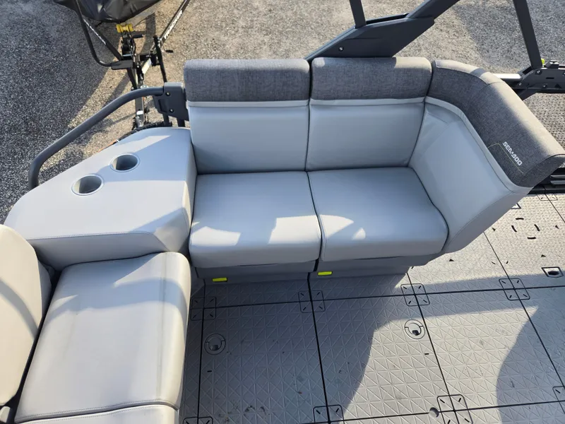 Slide: The Image of 2023 Sea-Doo Switch Cruise 18 interior seating with cup holders, featuring gray upholstery. - 9