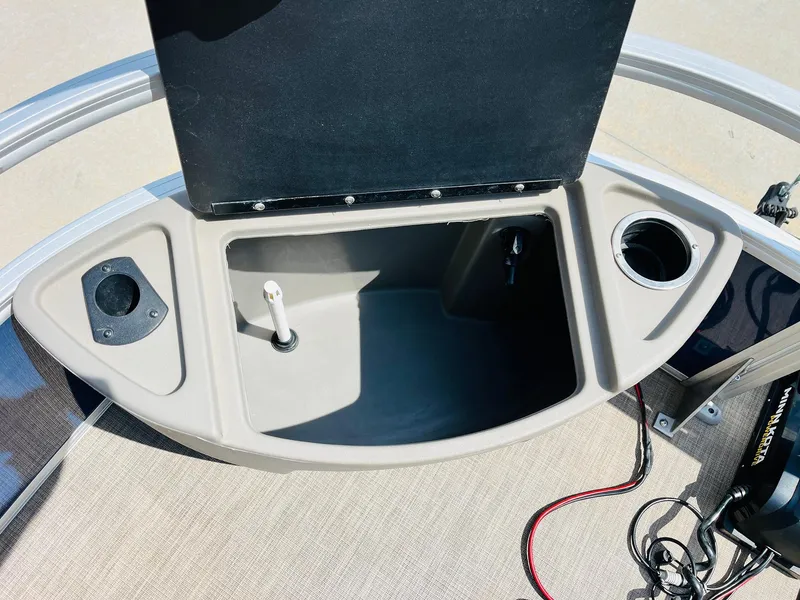 Slide: The Image of 2023 Sun Tracker Bass Buggy 18 DLX boat storage compartment with cup holder and wiring. - 12