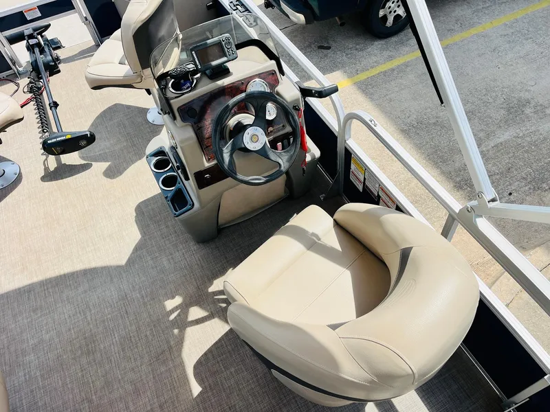 Slide: The Image of 2023 Sun Tracker Bass Buggy 18 DLX boat interior with steering console and seating. - 19