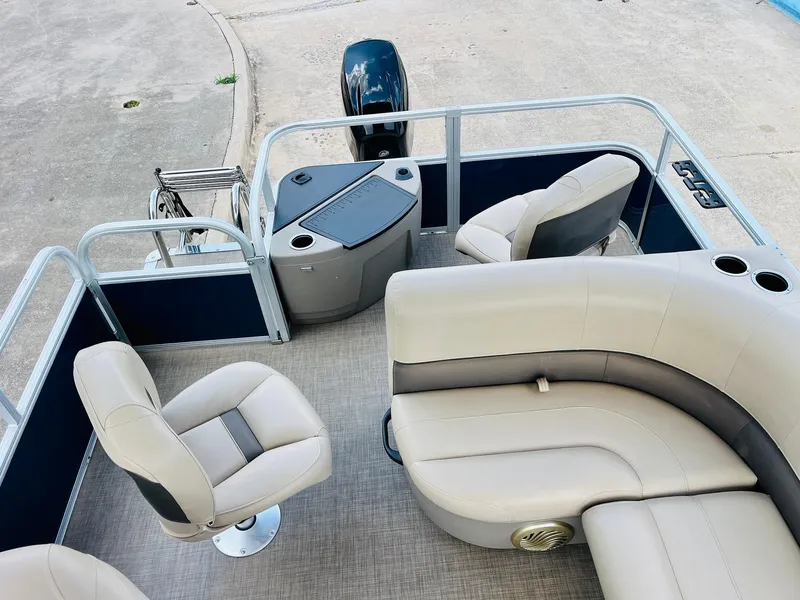 Slide: The Image of 2023 Sun Tracker Bass Buggy 18 DLX pontoon boat interior with seating and console. - 23