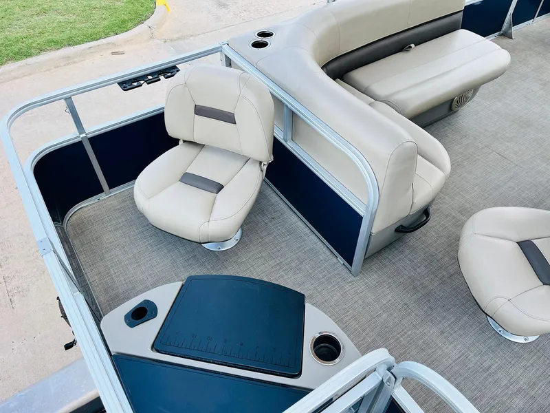 Slide: The Image of 2023 Sun Tracker Bass Buggy 18 DLX interior with beige seating and fishing station. - 24