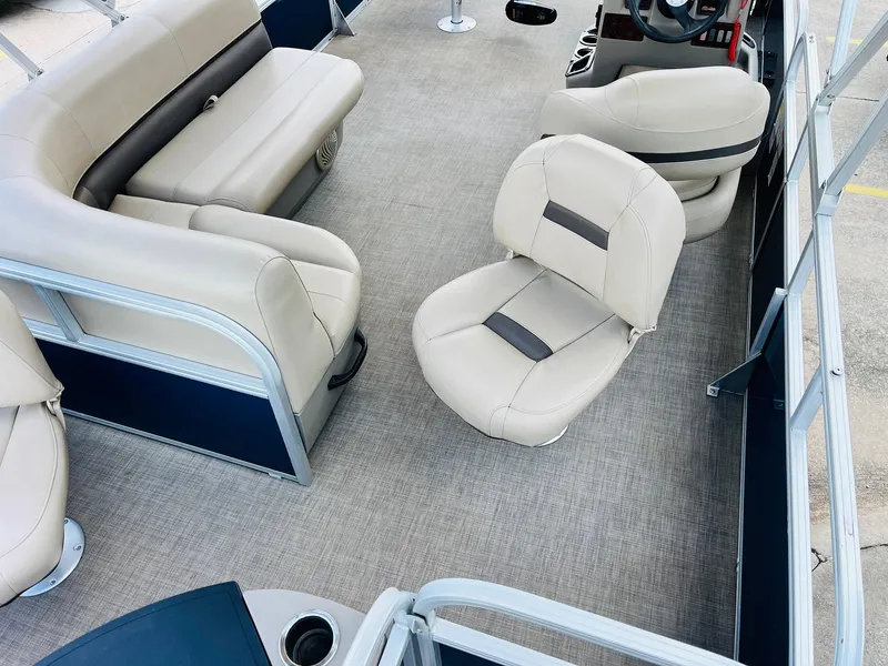 Slide: The Image of 2023 Sun Tracker Bass Buggy 18 DLX interior with beige seating and spacious layout. - 25