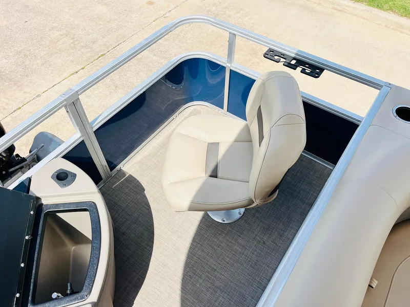 Slide: The Image of 2023 Sun Tracker Bass Buggy 18 DLX boat interior with beige seating and storage compartment. - 27