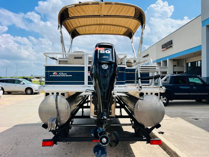 Slide: The Image of 2023 Sun Tracker Bass Buggy 18 DLX pontoon boat with canopy and outboard motor. - 5