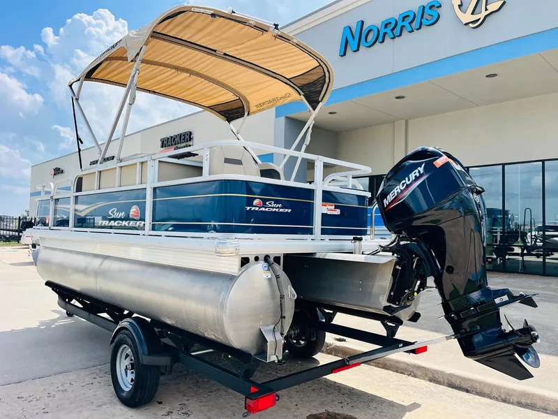 Slide: The Image of 2023 Sun Tracker Bass Buggy 18 DLX pontoon boat with Mercury engine at dealership. - 6