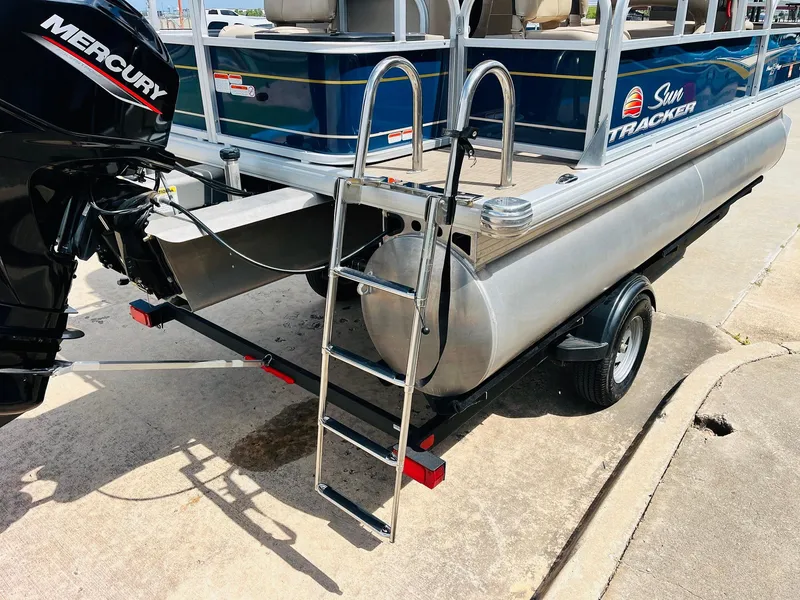 Slide: The Image of 2023 Sun Tracker Bass Buggy 18 DLX pontoon boat with Mercury engine and boarding ladder. - 7