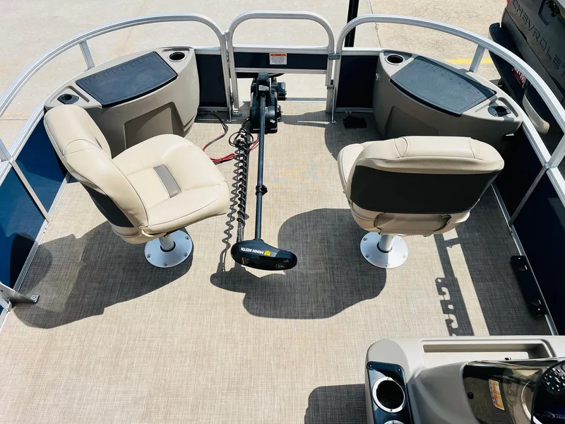 Slide: The Image of 2023 Sun Tracker Bass Buggy 18 DLX interior with two swivel seats and trolling motor. - 9