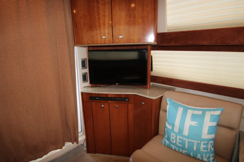 Slide: The Image of Interior of 2007 Meridian 391 Sedan with TV, wooden cabinets, and decorative pillow. - 11