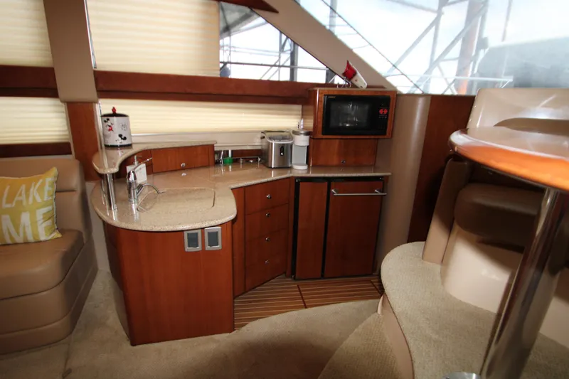 Slide: The Image of Interior of a 2007 Meridian 391 Sedan yacht with kitchenette and seating area. - 16