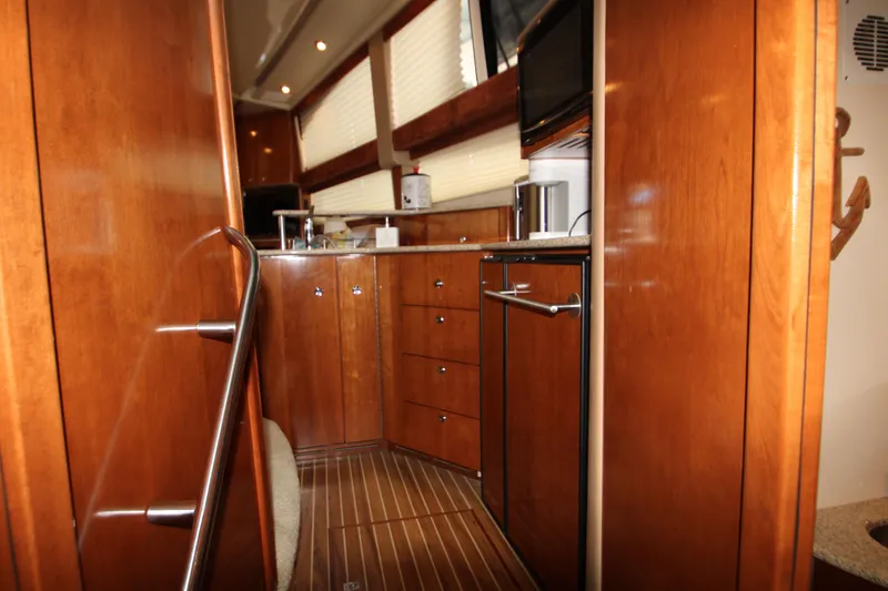 Slide: The Image of Interior of 2007 Meridian 391 Sedan yacht with wooden cabinetry and modern appliances. - 17