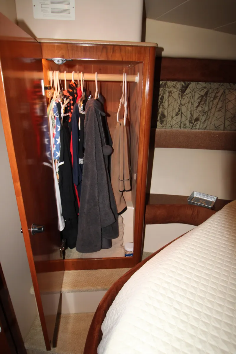 Slide: The Image of Closet with clothes inside a 2007 Meridian 391 Sedan yacht bedroom. - 22