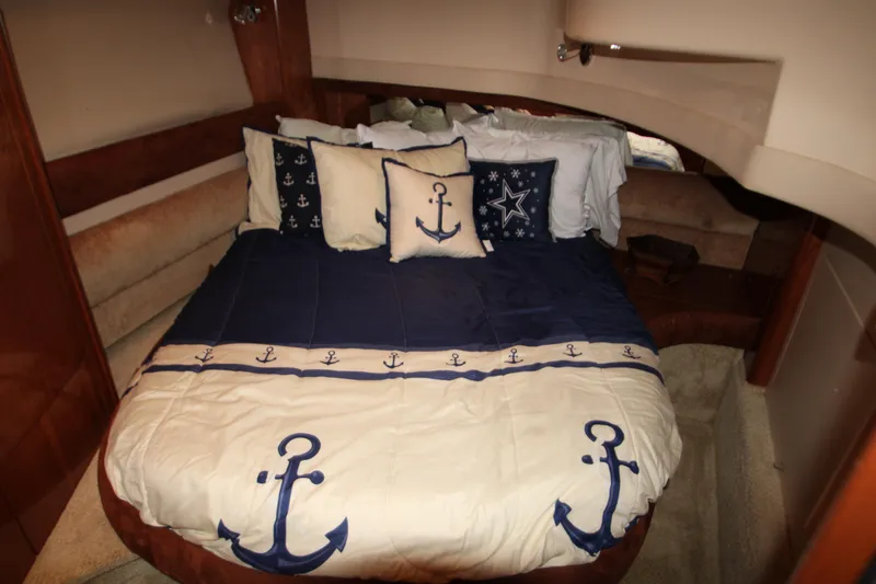 Slide: The Image of Luxurious bedroom in 2007 Meridian 391 Sedan with nautical-themed bedding and anchor decor. - 25