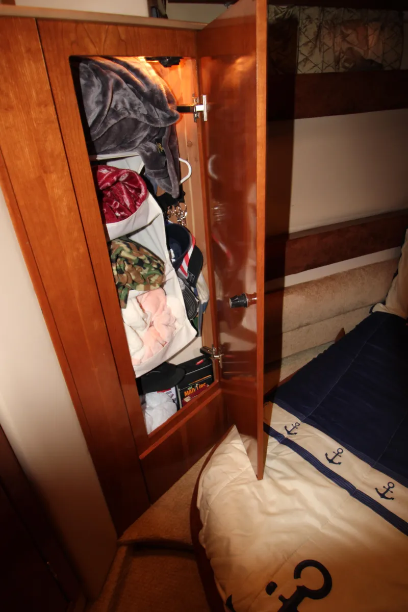 Slide: The Image of Wooden closet in 2007 Meridian 391 Sedan, filled with clothes and accessories. - 28