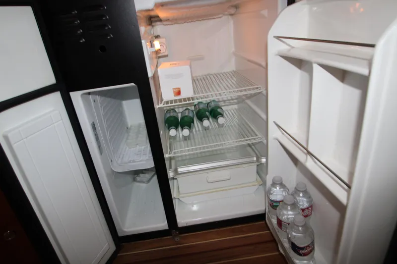 Slide: The Image of Open refrigerator in 2007 Meridian 391 Sedan, stocked with bottled water and beverages. - 34