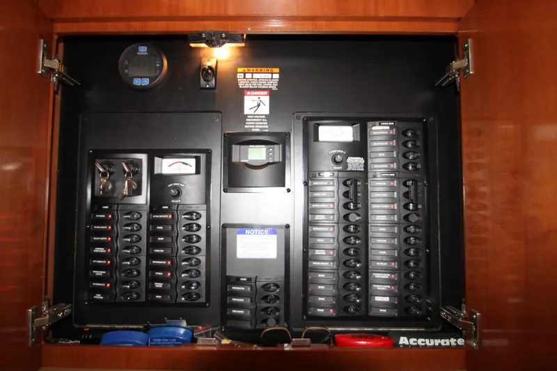 Slide: The Image of Electrical panel inside a 2007 Meridian 391 Sedan boat, featuring switches and meters. - 36