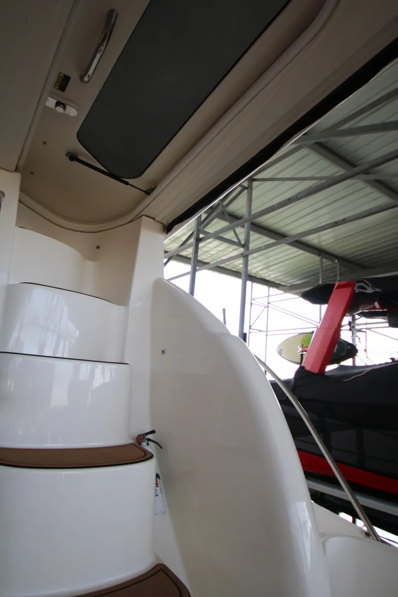 Slide: The Image of Staircase inside 2007 Meridian 391 Sedan yacht, docked under a metal roof. - 38