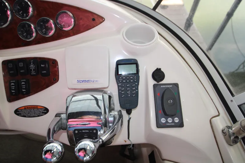 Slide: The Image of Control panel of a 2007 Meridian 391 Sedan boat with navigation and throttle controls. - 44